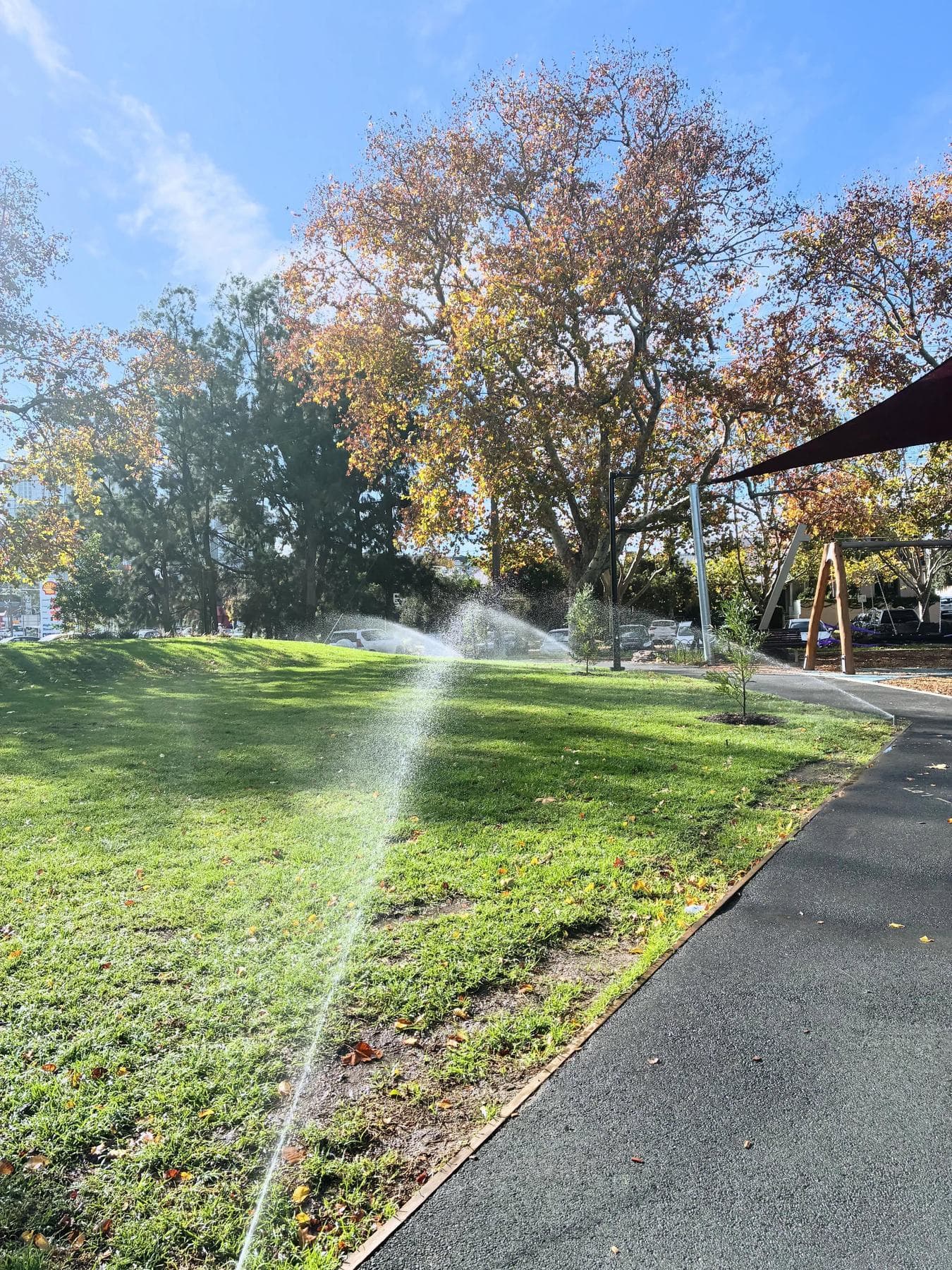 Finished irrigation system operating across the lawn at Sol Green Reserve