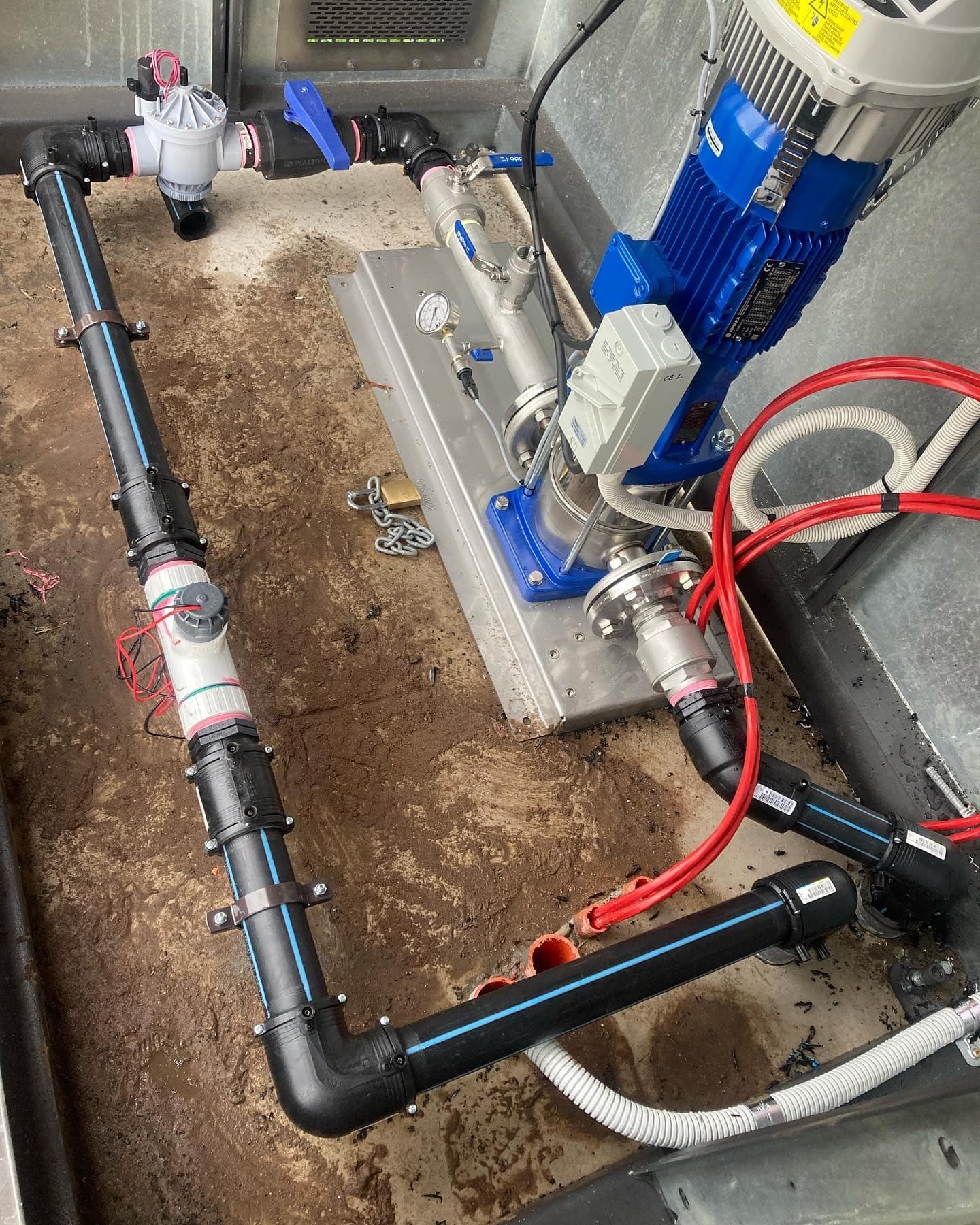 Open irrigation pump cabinet showing the internal pump, pressure vessel, pipework and control equipment
